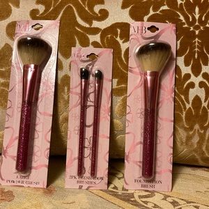 Set of four brushes with hot pink glitter handle. Must have beauty. New in pkg.
